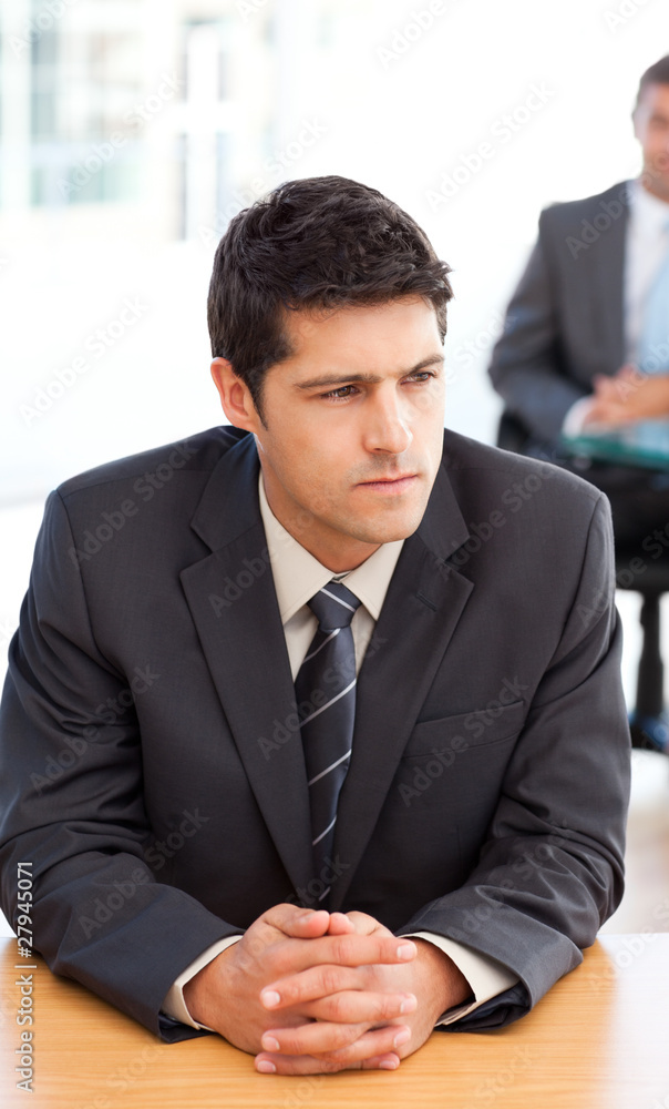 Thoughtful businessman during a meeting with a colleague Thoughtful businessman during a meeting with a colleague