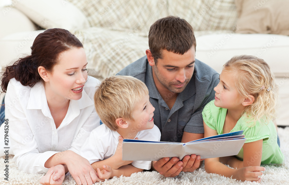 Cute family reading a children's book Cute family reading a children's book