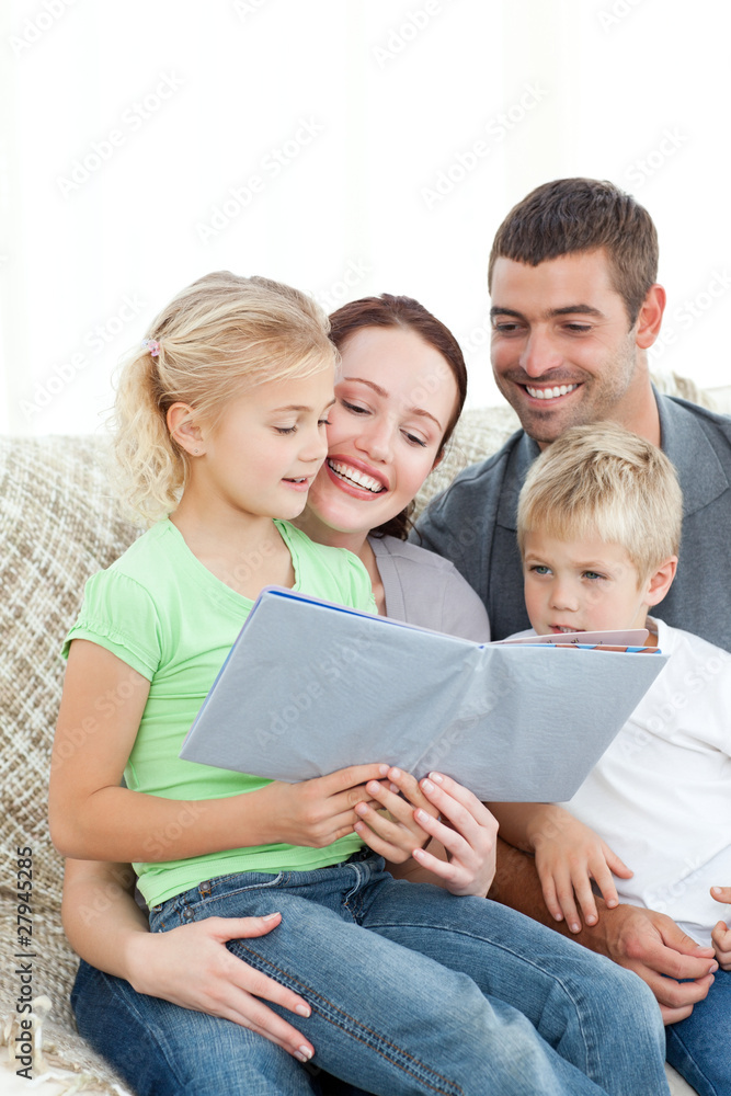 © WavebreakMediaMicro - Adorable family reading a book together in the living-room © WavebreakMediaMicro - Adorable family reading a book together in the living-room