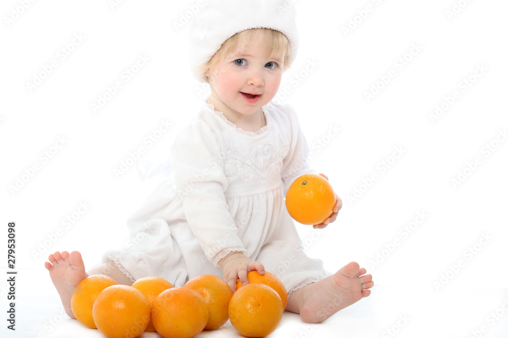 Smiling barefooted baby with oranges Smiling barefooted baby with oranges