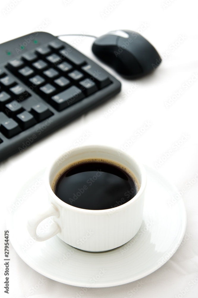 White coffee cup and black keyboard White coffee cup and black keyboard