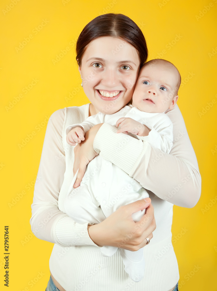 mother with her baby over yellow