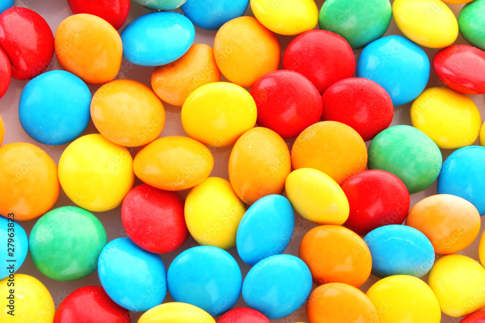 background of multicolored candy coated chocolate sweets background of multicolored candy coated chocolate sweets