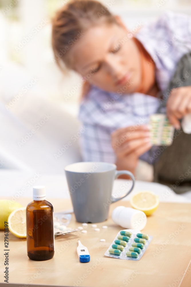 Vitamins medicines for flu woman in background Vitamins medicines for flu woman in background