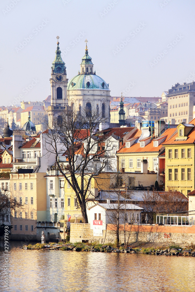 Fototapeta premium First Snow in Prague, St. Nicholas' Cathedral in the sunny Day