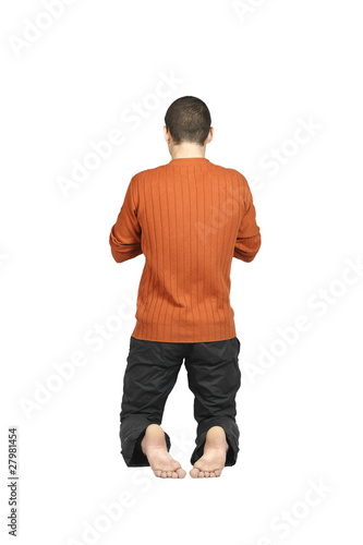 a man kneeling with his back