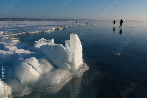 Scandinavian ice skaters on a large frozen lake