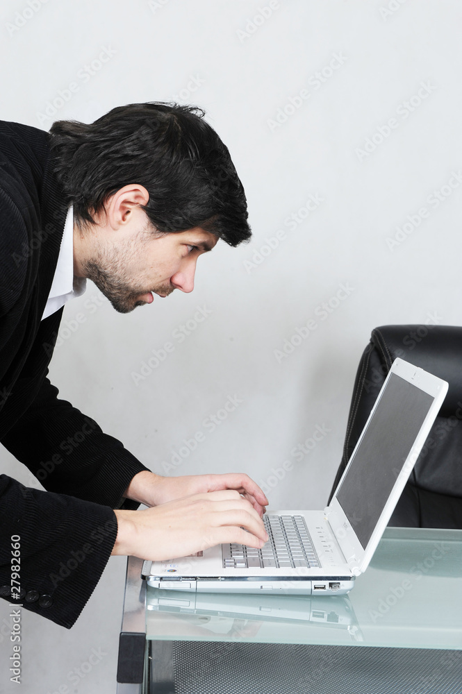 young businessman with his computer young businessman with his computer