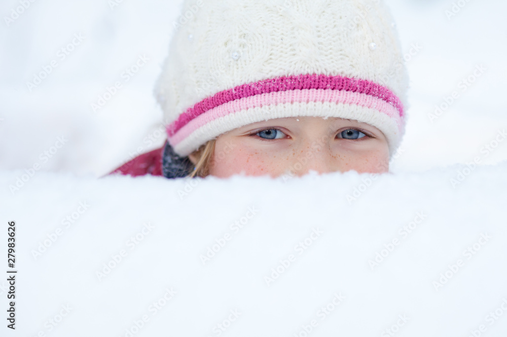 little girl look out of snowdrift with smiley eyes little girl look out of snowdrift with smiley eyes