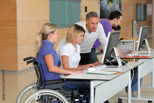 Woman in wheelchair working in the office