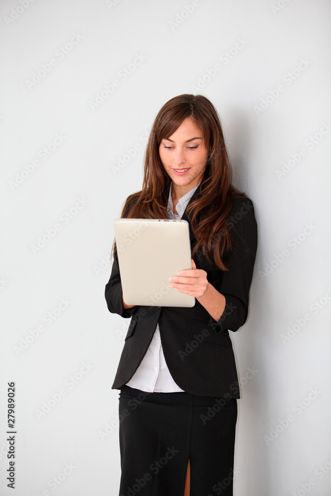 Businesswoman standing in hall with electronic pad Businesswoman standing in hall with electronic pad