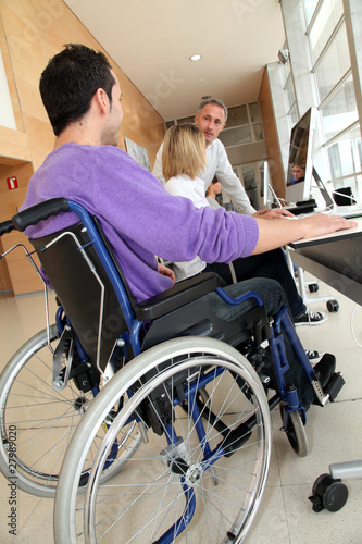 Man in wheelchair working in the office