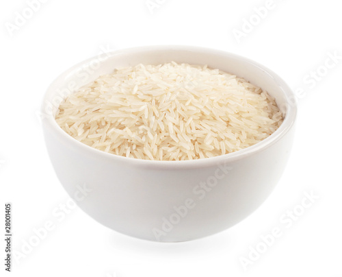 Uncooked rice in a ceramic bowl isolated on white