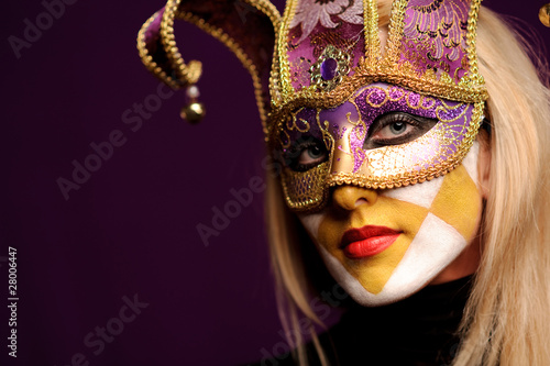 Fototapeta Naklejka Na Ścianę i Meble -  calm woman in violet party mask