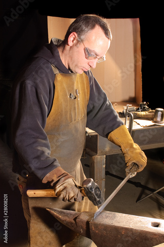 Blacksmith working on decorative handrail photo