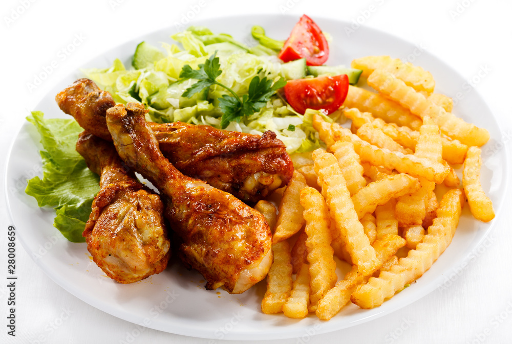 Grilled chicken drumsticks, chips and vegetables Grilled chicken drumsticks, chips and vegetables
