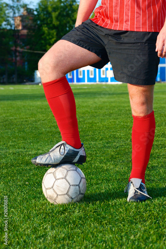Fototapeta Naklejka Na Ścianę i Meble -  man is standing on football field with ball