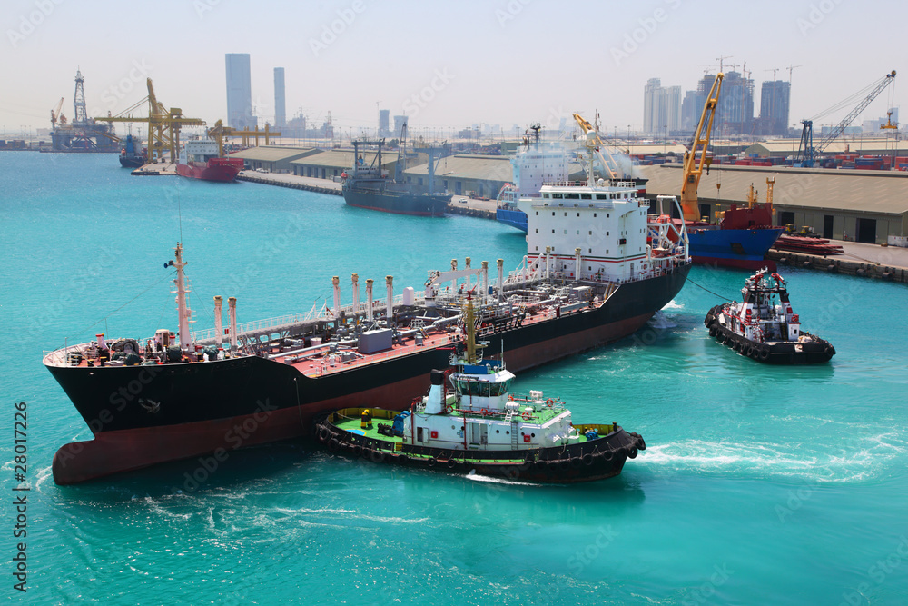 boats docked to industrial ship in port sail to sea at sunny day boats docked to industrial ship in port sail to sea at sunny day