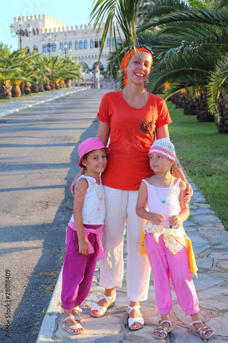 Woman with two girls is in way which conducts in palace photo