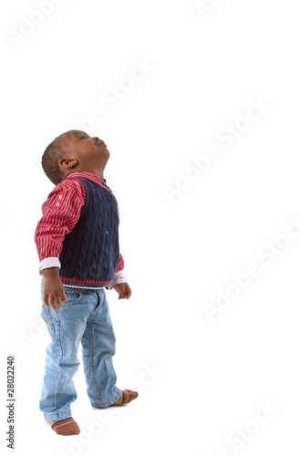 Cute young black boy looking