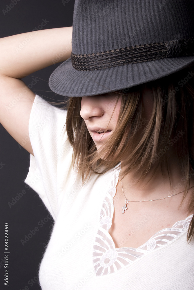 Portrait of a young fashionable brunette in hat . Portrait of a young fashionable brunette in hat .