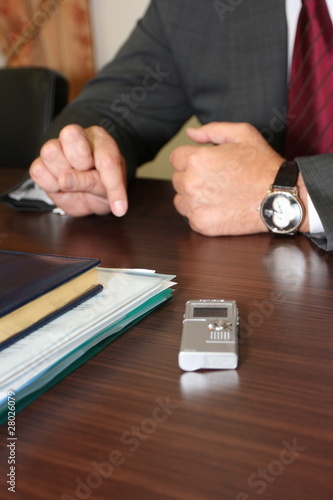 Hands of businessman giving an interview being recorded photo