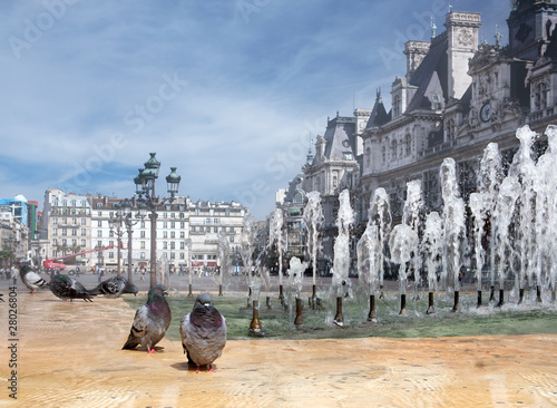 Kind on a fountain with pigeons against the mayoralty in Paris. photo