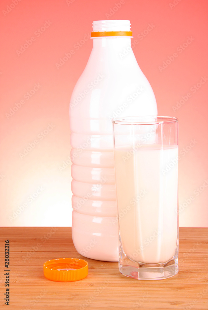 Bottle of milk and glass on red background Bottle of milk and glass on red background
