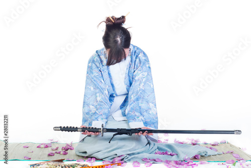 submissive geisha in blue kimono with katana