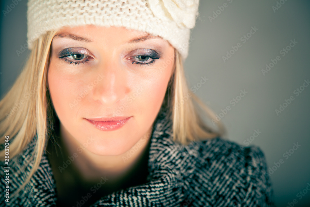 Portrait of beautiful blond woman in warm clothes on blue Portrait of beautiful blond woman in warm clothes on blue