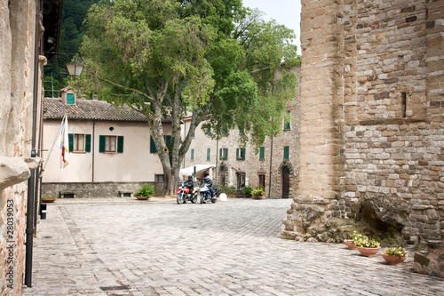 Zwei Motorradfahrer auf Platz in San Leo, Italien, Marken