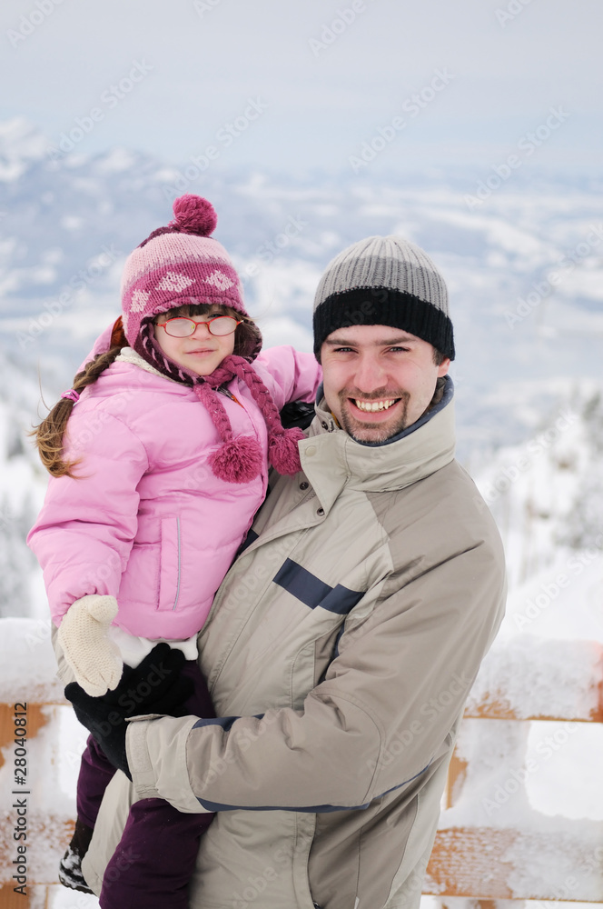 Father and daughter in winter mountain