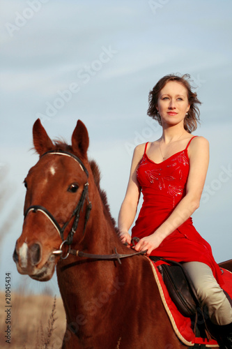 Woman riding horse in the field