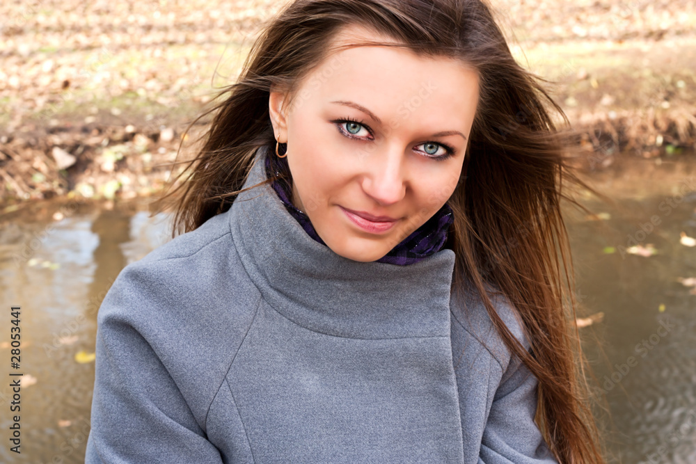 Cute young girl near a pond