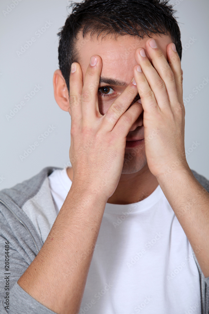 Closeup of young man hiding face whit hands Closeup of young man hiding face whit hands
