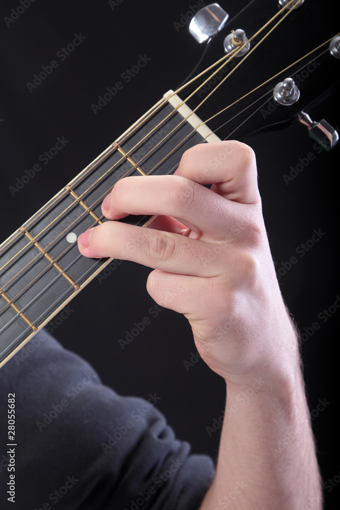 Human hand taking D-minor accord at guitar Human hand taking D-minor accord at guitar