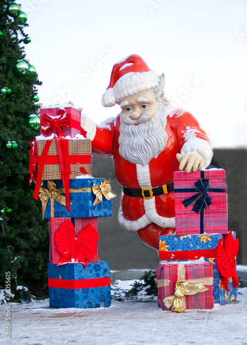 Santa claus with presnts and christmas tree
