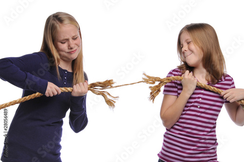 Two girls fighting over a rope photo