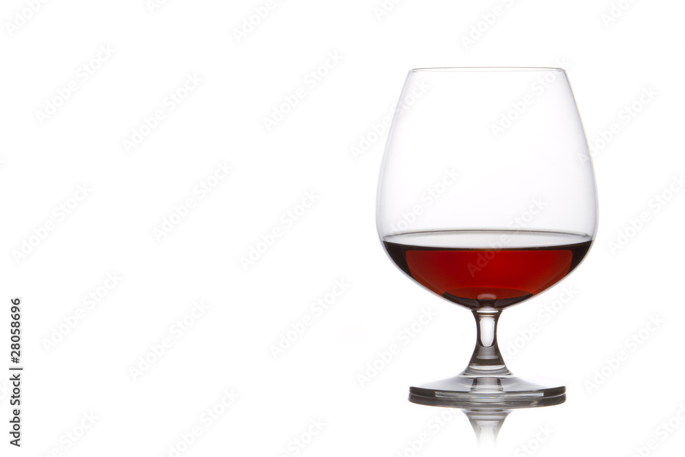 Glass of brandy over white background