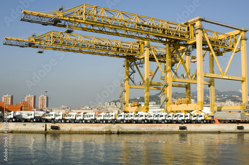 Genoa harbor - Container terminal and row of new trucks - Italy