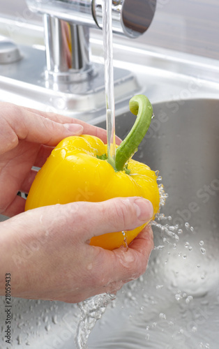 Washing a yellow pepper - close up