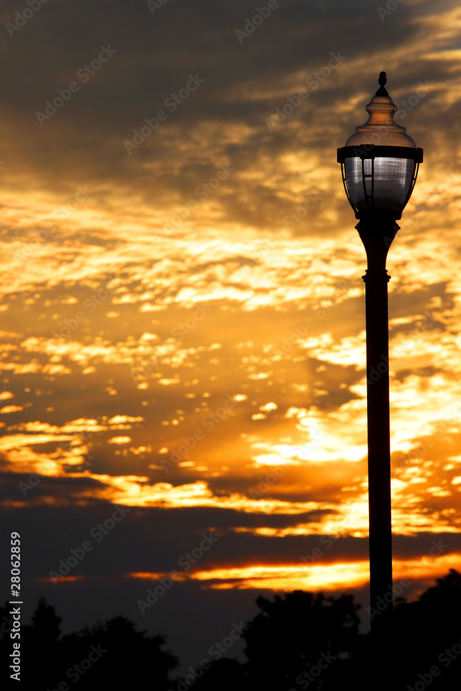 Old lamp post against cloudy evening sky