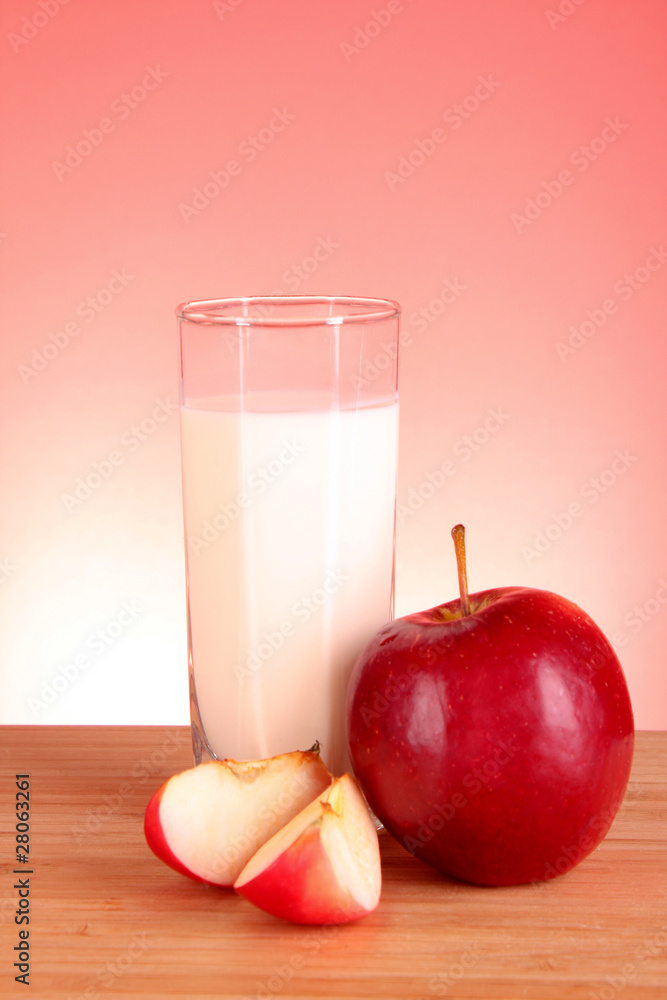 Apple and milk on red background Apple and milk on red background