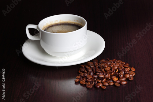 cup with coffee and coffee beans
