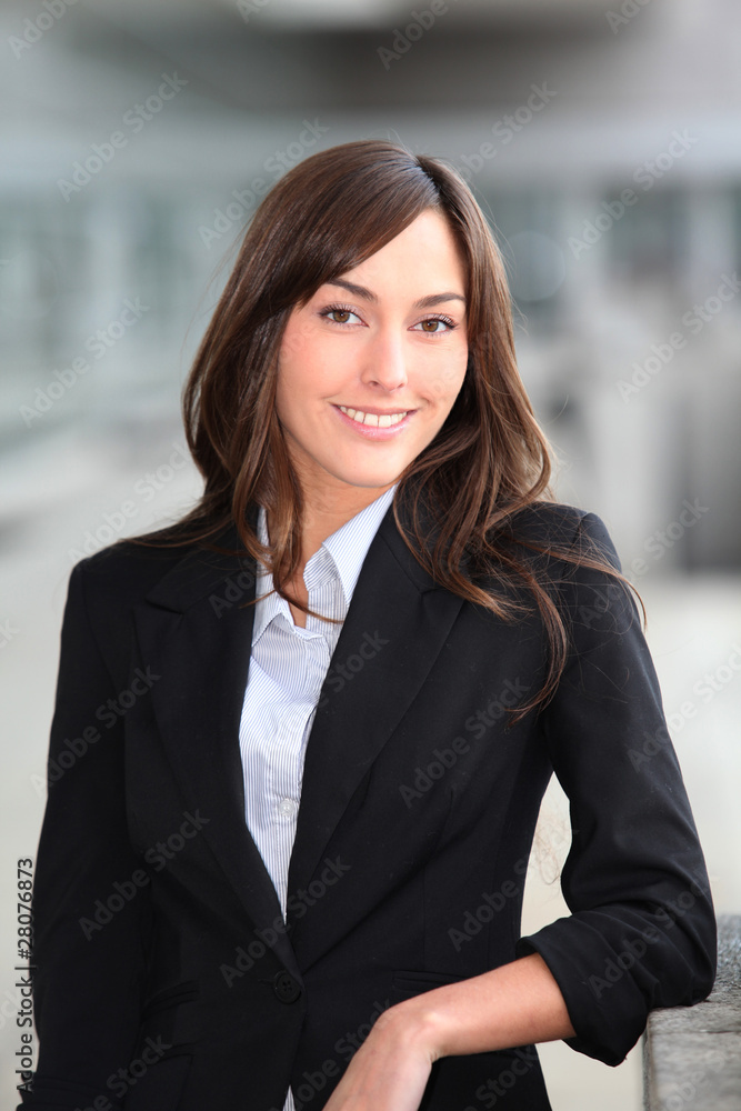 Closeup of beautiful businesswoman standing outside the office Closeup of beautiful businesswoman standing outside the office