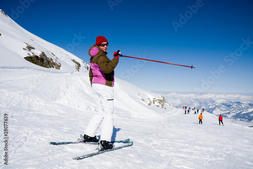 Woman skier pointing ski slope