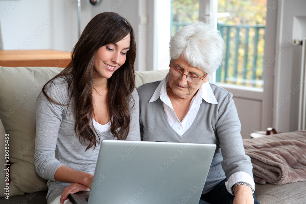 Young woman and elderly woman with laptop computer Young woman and elderly woman with laptop computer