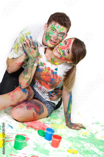 young happy couple painting over white