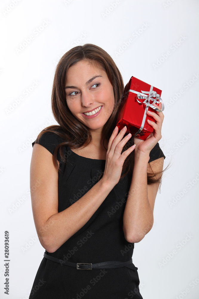 Smiling young woman with christmas gift Smiling young woman with christmas gift