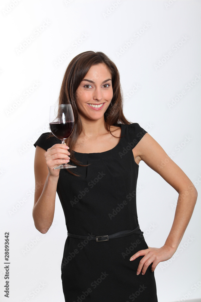 Beautiful woman in black dress tasting red wine Beautiful woman in black dress tasting red wine